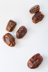 Dried halawi dates on a white