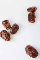 Dried halawi dates on a white