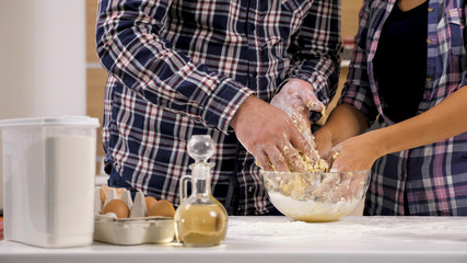 Beautiful young couple playing with flour while cooking. Having fun