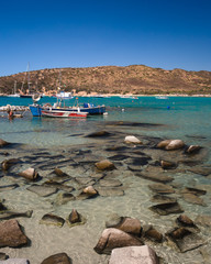 Fishing boats moored near Punta Molentis beach, Villasimius, Sardinia, Italy.