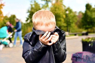 little boy playing hide