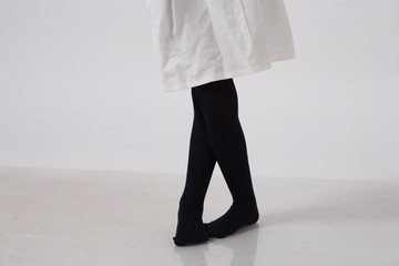model in black tights in white studio