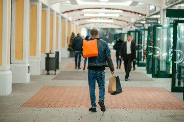 Handsome young man doing his holiday shopping