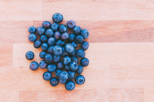 Heap of blueberries on parquet