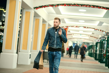 Handsome young man doing his holiday shopping