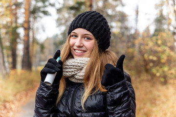 young woman with runny nose and using a nasal spray