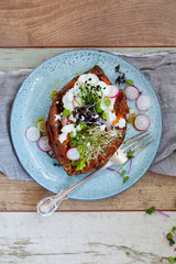 Sweet potato with mashed avocado, yogurt and sprouts