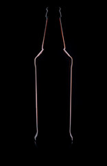 Silhouette of a glass bottle on a black background