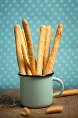 Vintage iron mug with bakery - bread sticks or grissini