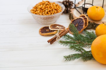Orange and sea buckthorn on a white wooden background, christmas food,  concept of seasonal vitamins and healthy eating. Copy space