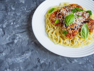 A plate of pasta and braised eggplant with Parmesan. Close up.