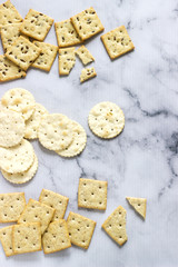 Matzo crackers, salty crackers with sesame seeds and flax seeds on a light background.