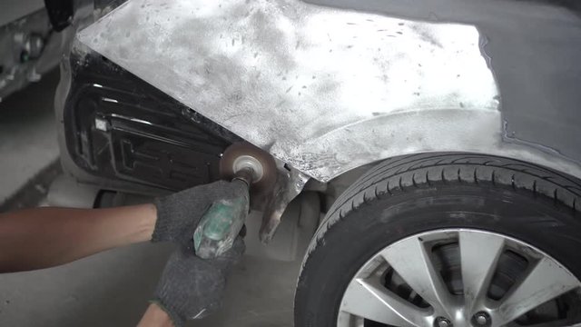 Car body work after the accident by preparing automobile for painting during repair