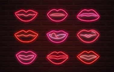 Vector neon lips signs over brickwall background © D Graphics