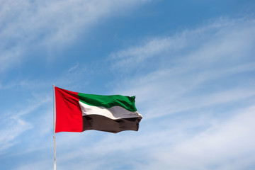 UAE flag waving in the sky, national symbol of UAE. UAE National Day. UAE flag day.