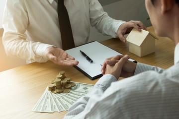 Businessmen offer an exchange of buy-sell contracts. Businessman Insurance Home Concepts.