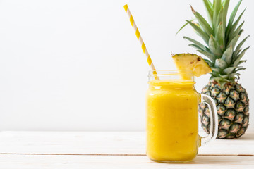 fresh pineapple smoothie glass on wood table