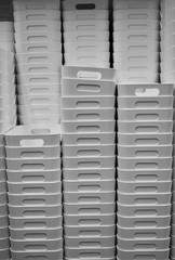 Stack of white plastic storage boxes with handles