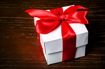 white gift box with red bow