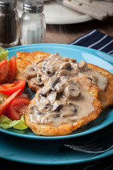 Crispy fried homemade potato pancakes with mushroom sauce.