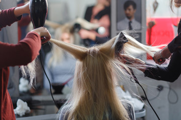 Two masters at the same time dried with hair dryers hair