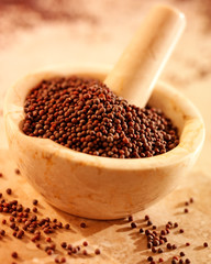 BLACK MUSTARD SEEDS IN PESTLE AND MORTAR