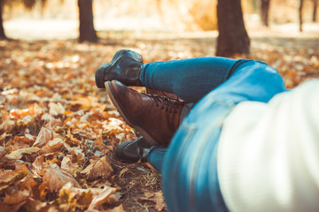 Kind couple lying with crossed legs outdoors
