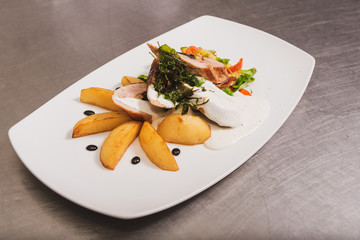 Royal file and potatoes sprinkled with white sauce with dried plums