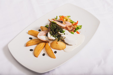 Royal file and potatoes sprinkled with white sauce with dried plums