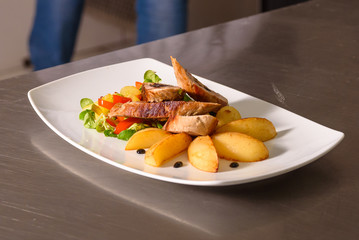 Royal file and potatoes sprinkled with white sauce with dried plums