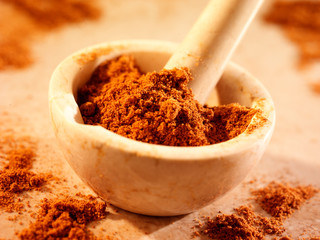 GROUND NUTMEG IN PESTLE AND MORTAR