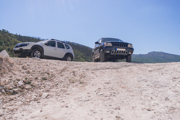 Obraz na płótnie Canvas two off road vehicles in marble quarry