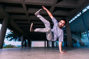 Young man practicing parkour on the ground