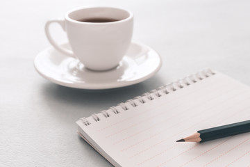  Notebook, pencil and white cup of coffee. Close up. Business, education concept. Morning time