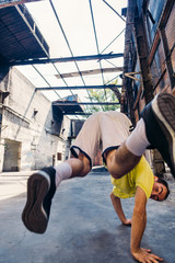 Parkour man exercise handstand outdoors