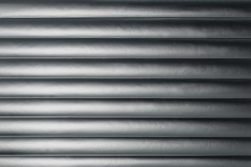 Abstract silver background with horizontal lines, lit with a soft light.
