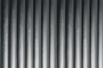 Abstract silver background with vertical lines, lit with a soft light.