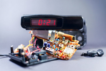 broken electronic clock shows time. the details of the board, transistors