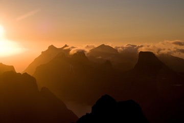 Lofoten midnight sun over sharp mountains of Moskenesoya seen from Munken peak summit, sunset and sunrise combined, Norway