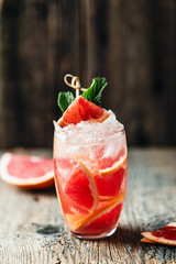 Fresh grapefruit cocktail. Fresh summer cocktail with grapefruit and ice cubes. Glass of grapefruit mojito