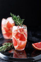 Fresh grapefruit cocktail. Fresh summer cocktail with grapefruit and ice cubes. Glass of grapefruit mojito