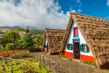 Fotobehang Traditional historic thatched houses with strawy roofs on Madeira island, Santana, Portugal © Jan