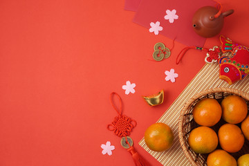 Chinese New Year background with traditional decorations for Spring festival on red table.