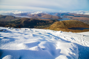 Hiking Ben Nevis in Scotland, Great Britain's highest mountain, on a sunny winter day 
