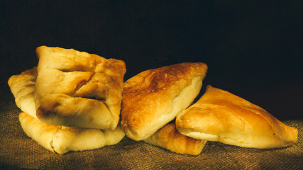 Close-up of pies on dark background. © Ринат Храмов