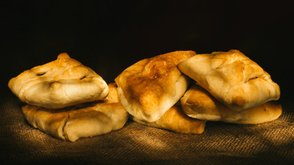 Close-up of pies on dark background.