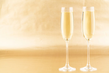 New Year background with glasses of champagne. Golden Holiday background