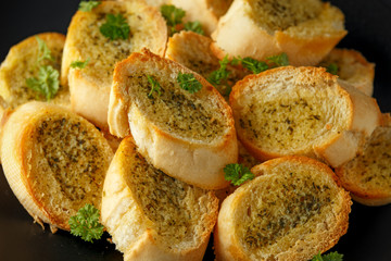 Fresh Garlic Bread, toast on black plate