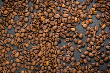 coffee grain (good and bad grain) - Arabica and Robusta blend (roasted coffee grain). Black background. Top view . Copy space.