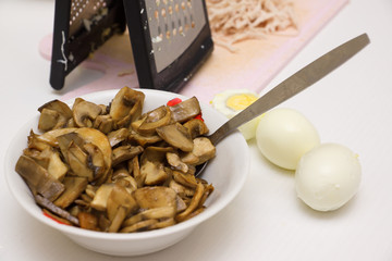 hostess with the help of a grater prepares the food